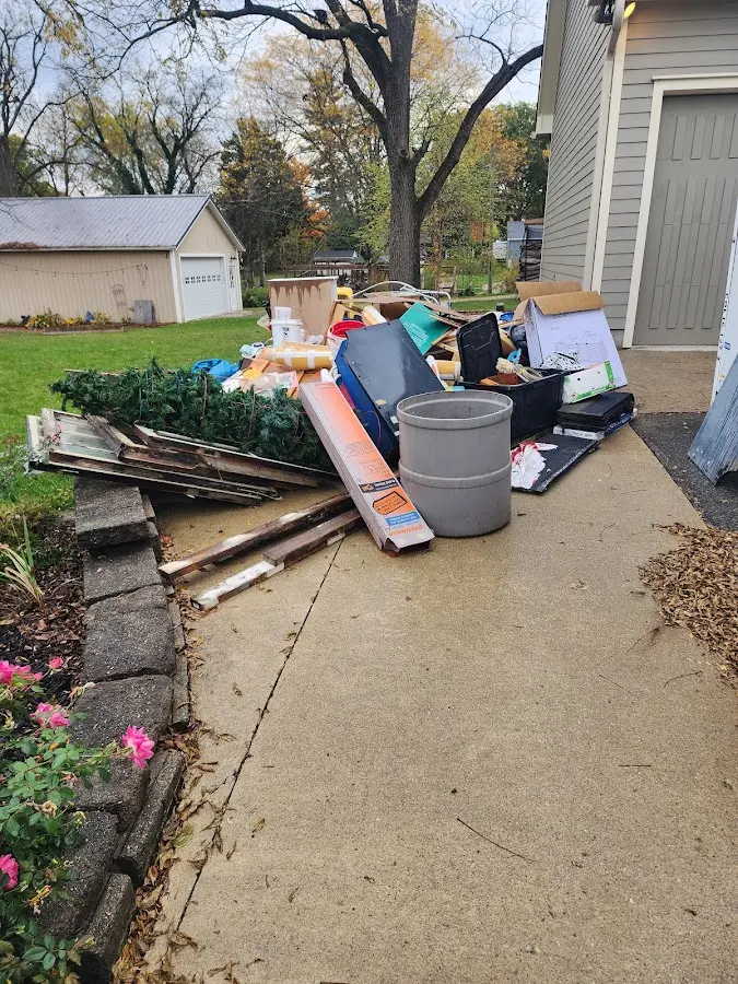 Dumpster being loaded with debris for 3 Yard Dumpster Rental in Hales Corners
